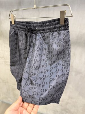 Black on black Off-White all-over stenciled monogram logo swim shorts